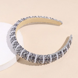 Detailed view of the wide sponge headband with gray rhinestones and small white pearls