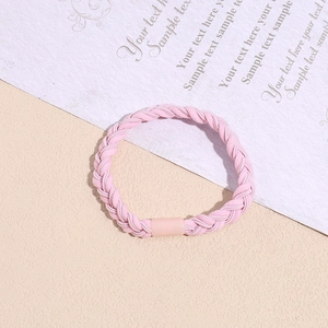 Detailed view of pink braided elastic hair tie with a smooth matching connector