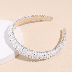 Detailed macro view of wide padded headband with white faux pearls and silver sequins