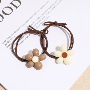 Floral elastic hair ties with woven brown bands and minimalist resin flower accents