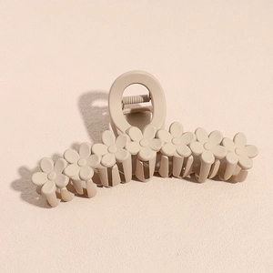 Detail of 13cm matte cream hair claw clip with seven decorative flower designs