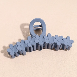 Detail of 13cm matte dusty blue hair claw clip with a continuous seven-flower design