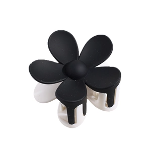Pince à cheveux fleur bicolore noir et blanc mat avec design géométrique