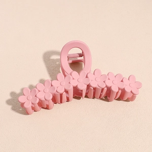 Detail of 13cm matte pink shark hair claw clip featuring seven 3D daisy flower ornaments