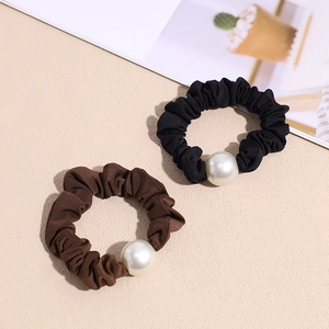 Elegant black and brown scrunchie set with large faux pearls on soft textured fabric