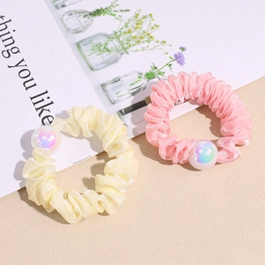 Lustrous organza scrunchies in pastel pink and yellow featuring gradient mermaid pearls