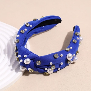 Detail of royal blue velvet headband with white pearls and sparkling crystal rhinestones