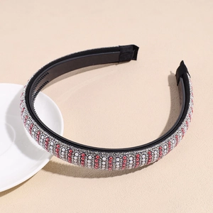 Close-up of handmade red and white pearls with silver sequins on a wide headband