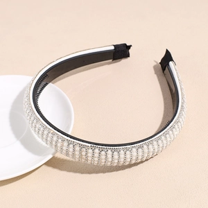 Detail view of handmade pearl headband with rhinestones and black anti-slip inner comb