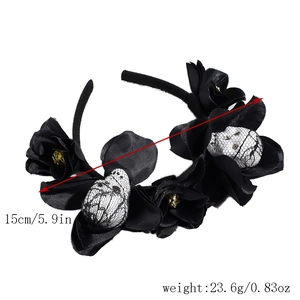 Detail view of gothic Halloween headband with black silk flowers and foam skull charms
