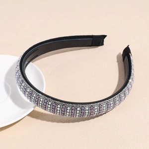 Close-up of handmade pearl and rhinestone headband with anti-slip teeth detail