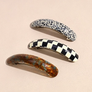 Three elegant acetate hair clips with leopard, checkered, and floral patterns