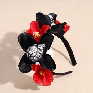 Halloween floral headband with red black faux roses and mesh skulls on a plain background