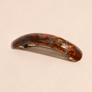 Detailed macro view of the marble texture on a curved leopard print acetate hair clip
