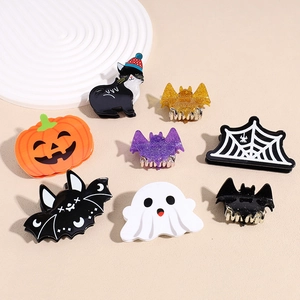 Detailed flat lay of Halloween hair clips featuring pumpkin, bat, and ghost designs