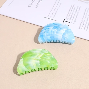Starry acrylic shark hair clips in blue and green marble patterns for elegant updos