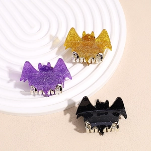 Halloween bat hair claws in glitter purple, gold and black on a white display plate