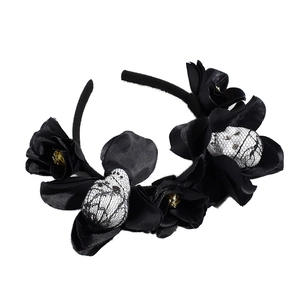 Gothic Halloween headband with black fabric flowers and lace-covered skulls on white background