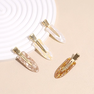 Set di 4 fermagli per capelli con motivo a scacchi marmorizzati e base dorata