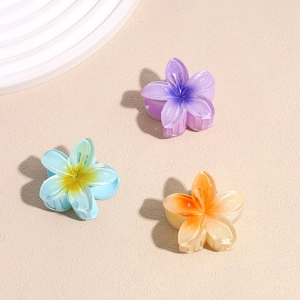 Colorful frangipani flower hair claws in purple, blue and orange matte acrylic