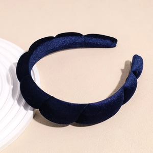 Detail of navy blue velvet padded headband with pleated texture and soft sponge design
