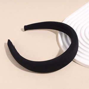 Detail view of thickened black sponge headband with smooth fabric texture and rounded shape