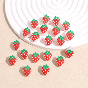 Mini strawberry hair clips for kids made of glossy red resin with green leaf details