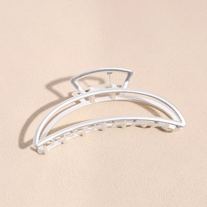 Detail view of matte silver crescent hair claw clip with spring and multi-tooth design