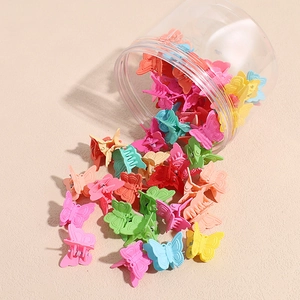 Close-up of colorful mini butterfly hair clips with transparent storage container