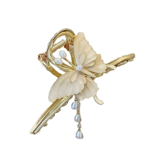 Elegant gold butterfly hair claw clip with white pearls and long tassel drop pendants