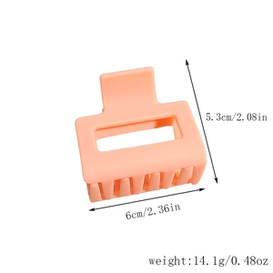 Detail shot of a 6cm square matte hair claw clip in pale peach pink with size annotations