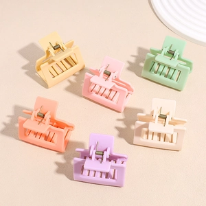 Set of 6 colorful square matte hair claws in macaron tones on a textured surface