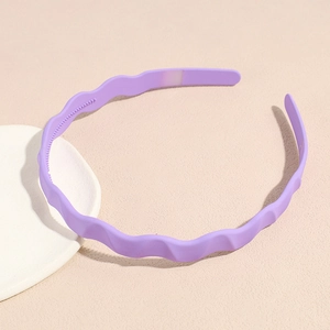 Detail view of purple wavy headband with anti-slip inner teeth and matte resin finish