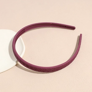 Detail view of burgundy matte headband with non-slip teeth and woven texture finish