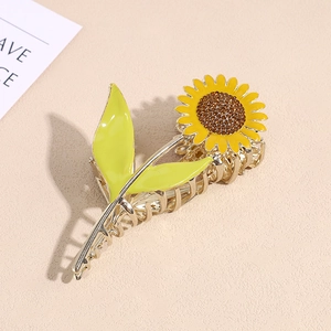 Detailed close-up of a sunflower hair claw clip with yellow petals and brown rhinestones