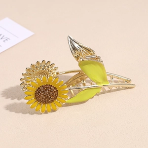 Elegant gold metal sunflower hair claw clip with rhinestones and green leaf design