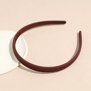 Close-up of matte dark red headband showing herringbone texture and non-slip inner teeth