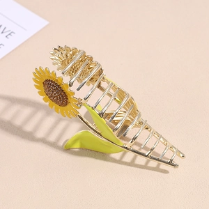 Elegant gold metal sunflower hair claw clip with yellow enamel and brown rhinestones