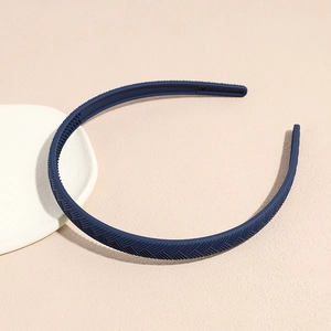 Detail of matte navy blue headband with refined herringbone textured pattern surface
