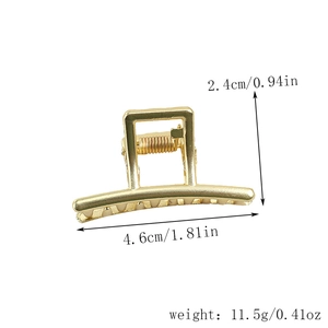 Detail view of small gold metal hair claw clip with size dimensions 4.6cm by 2.4cm