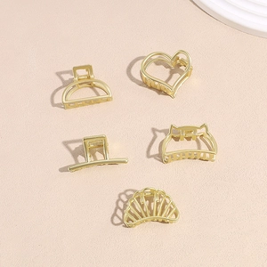 5-piece set of golden metal hair claw clips in heart, cat ear, and geometric shapes