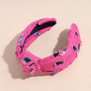Close-up of hot pink frayed wide headband showing blue and white plaid inner fabric