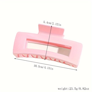 Detail view of pink rectangular hair claw clip with measurements in centimeters and inches