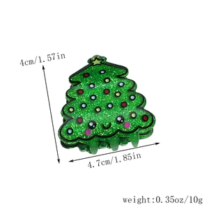 Detailed view of green Christmas tree hair claw clip with colorful sequins and dimensions