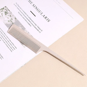 Detail of eco-friendly wheat straw tail comb with fine teeth on minimalist magazine background