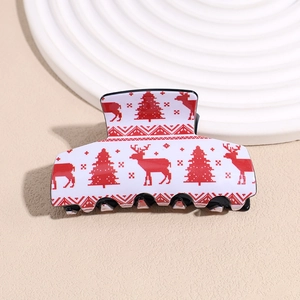 Macro detail of Christmas theme acrylic hair claw clip with festive elk and tree patterns