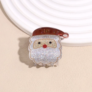 Detail of glitter Santa Claus hair claw clip with sparkling red and white finish