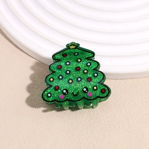 Detail view of a green glitter Christmas tree hair claw clip with colorful dot ornaments