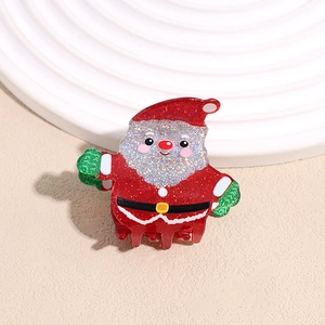 Detail view of Santa Claus hair claw clip with red glitter and white beard texture