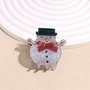 Close-up of cute snowman hair claw clip with glitter finish and festive scarf detail